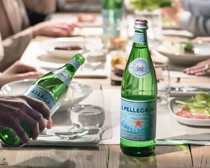 table of people with S. Pellegrino water bottles