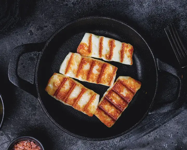 Baked halloumi in a skillet.
