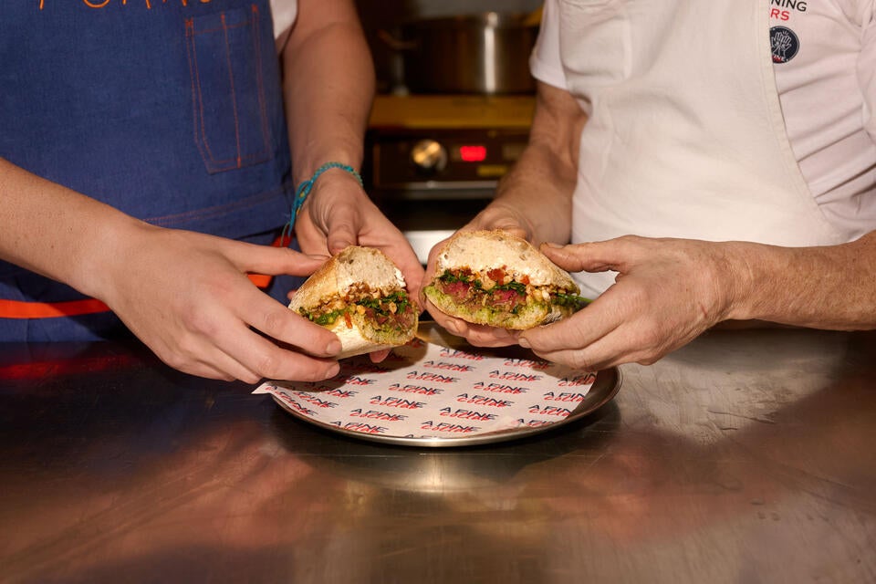 Two chefs holding the Fine Collab Sandwich in London.